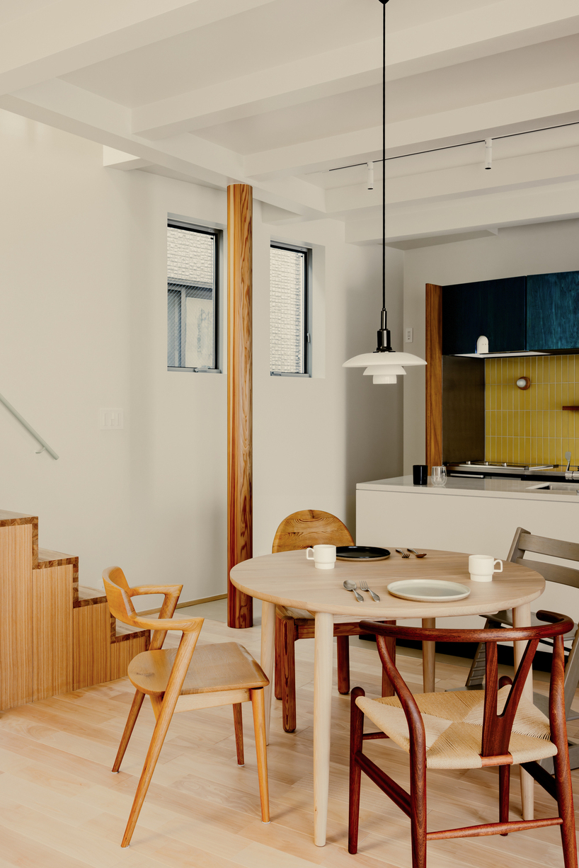 rotated interior wall shapes triangular sunlit voids within tiny wooden house in tokyo