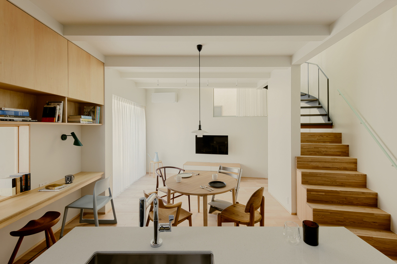 rotated interior wall shapes triangular sunlit voids within tiny wooden house in tokyo