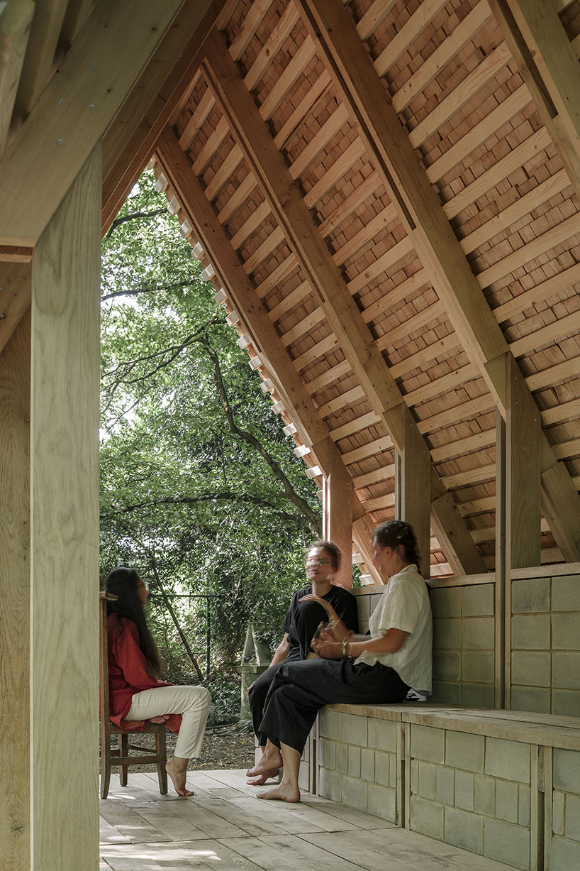 hasselt university students employ reclaimed timber and earth bricks for communal pavilion