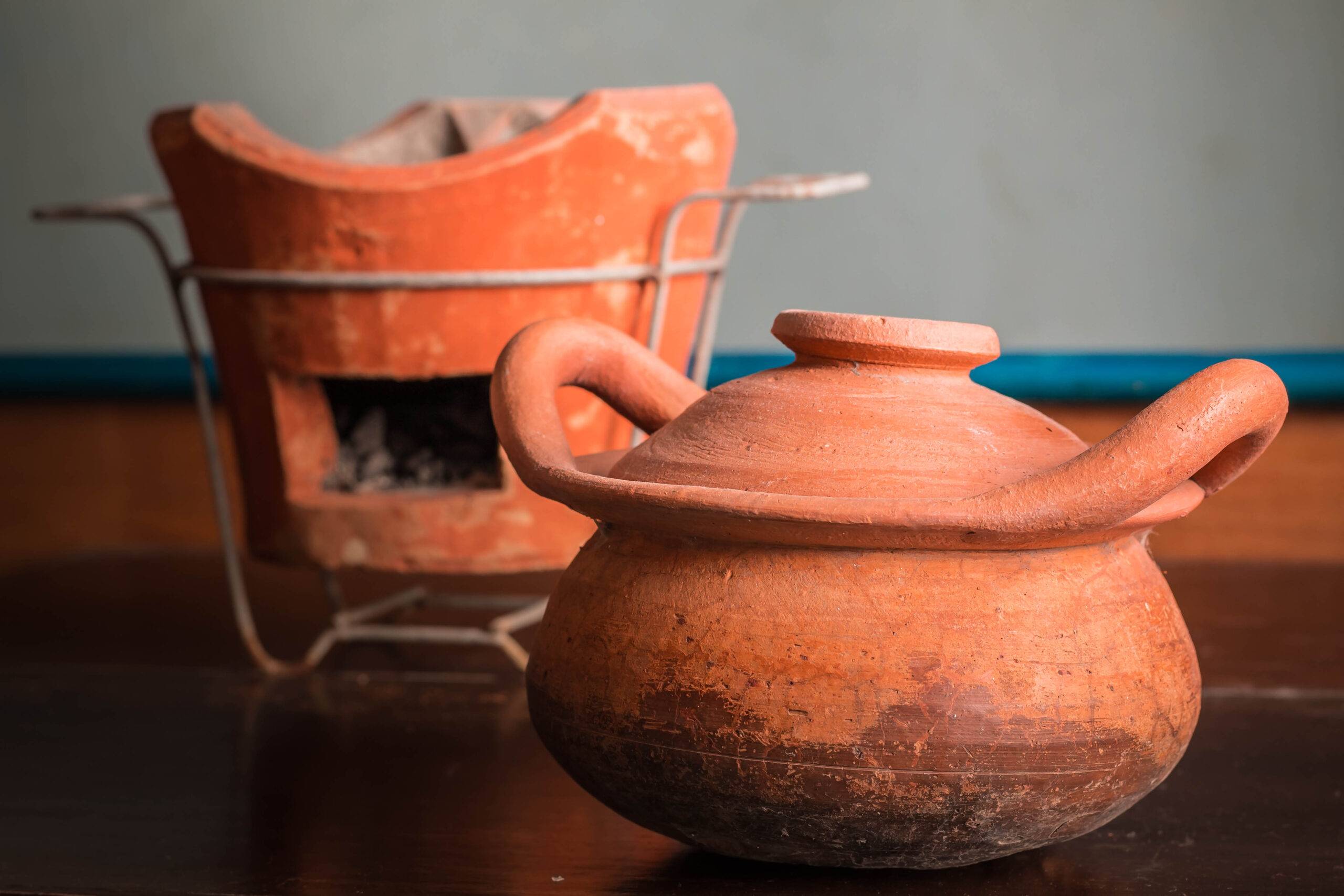 Clay pots and charcoal on old wood.