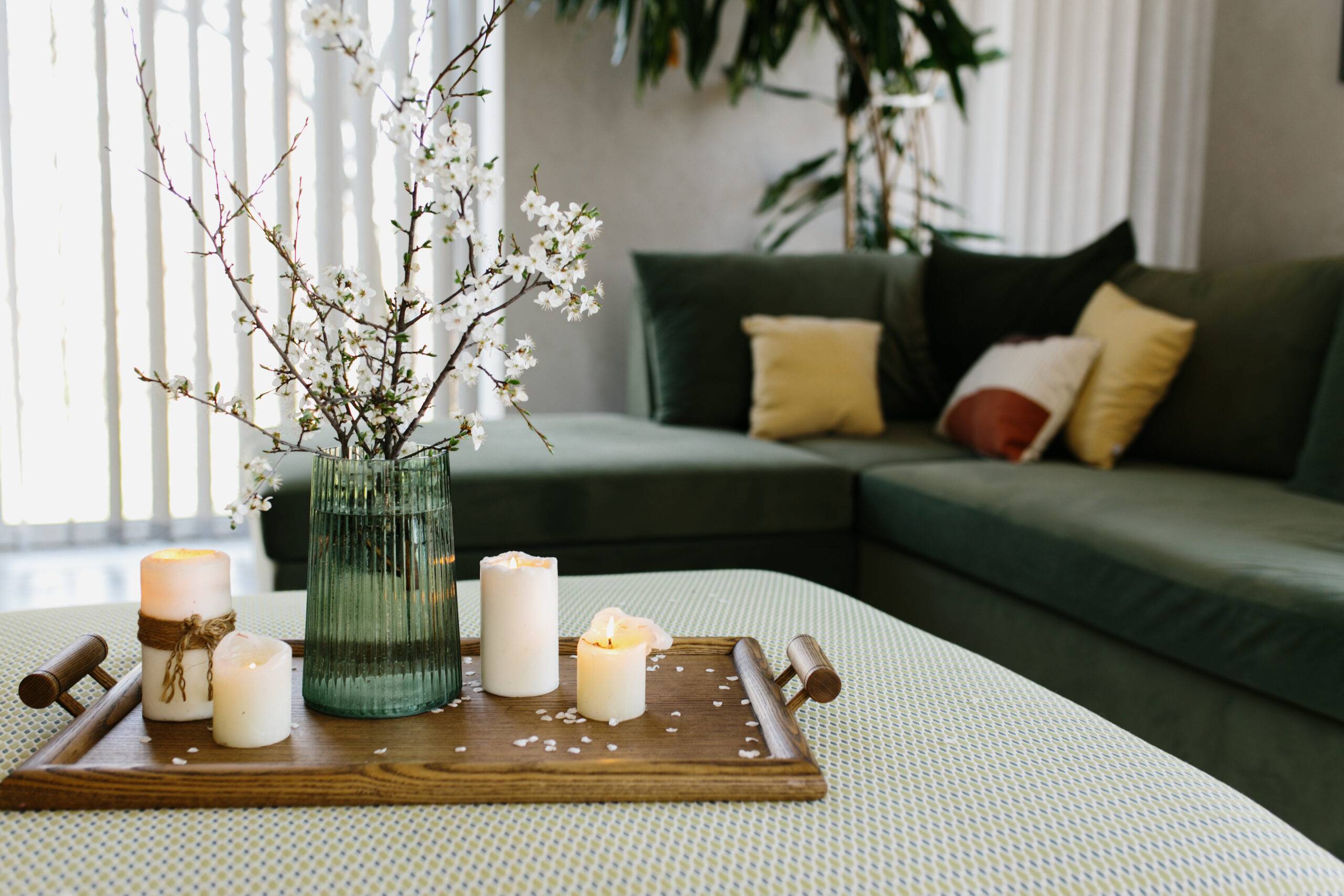 Home interior. Relaxing candles. Apple tree color has flown. Blurred background. High quality photo