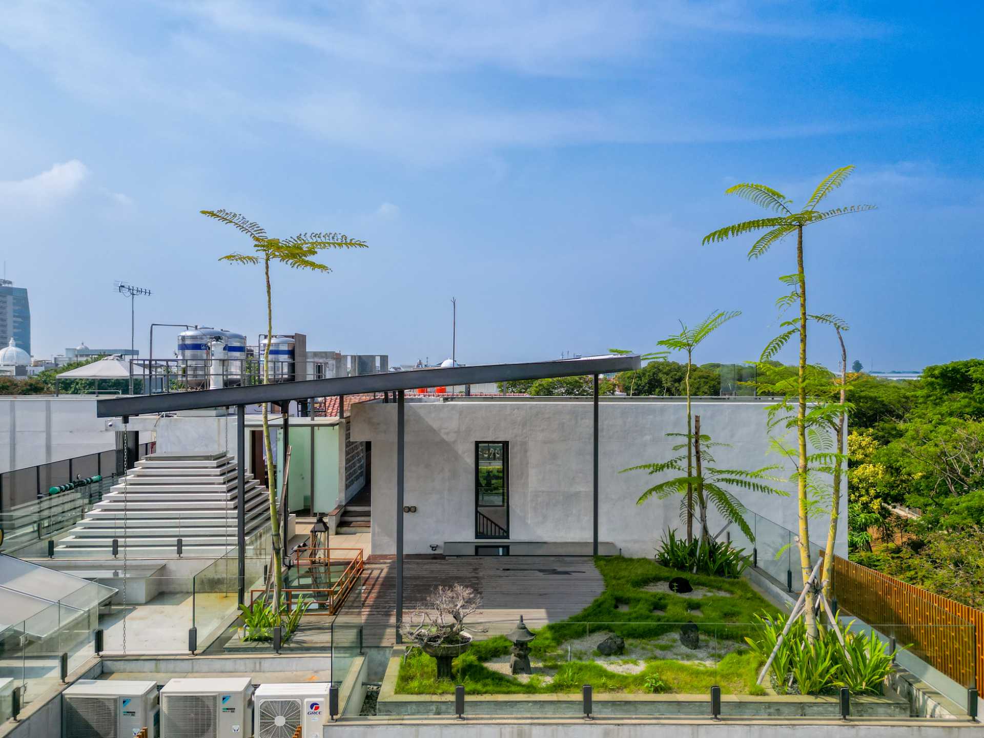 A modern home with a rooftop garden, outdoor kitchen, and multiple dining areas.