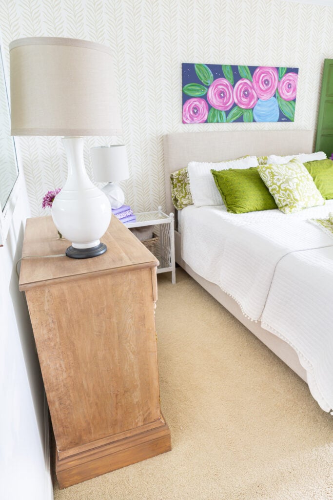 Guest room with stripped wood cabinet against wall.