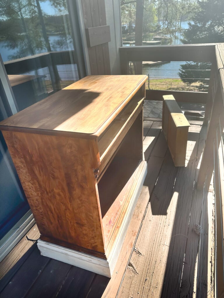 paint stripped wood cabinet set out in the morning sun to bleach