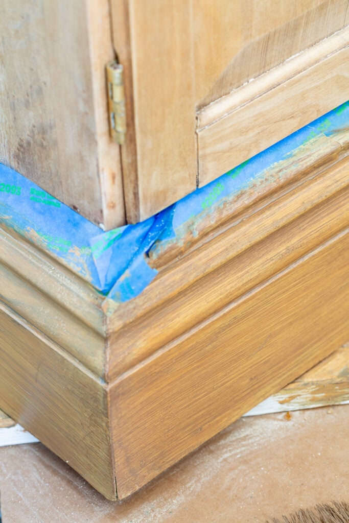close up shot of wood cabinet and trying to match the wood grain with paint.