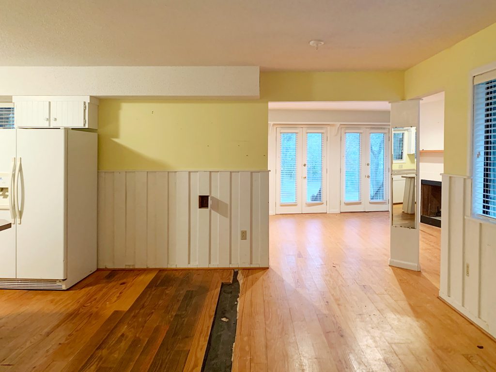 Before photo of kitchen with wide open doorway into former living room