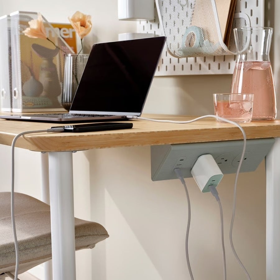 IKEA Just Made an Extension Cord You’ll Actually Want to Display 17 IKEA SKOTAT extension cord hung under a desk