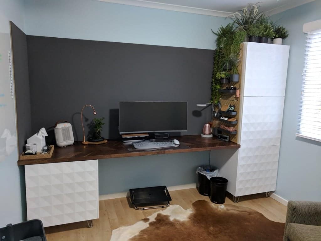 IKEA Desk Hacks featuring kitchen cabinets and countertop against dark wall background