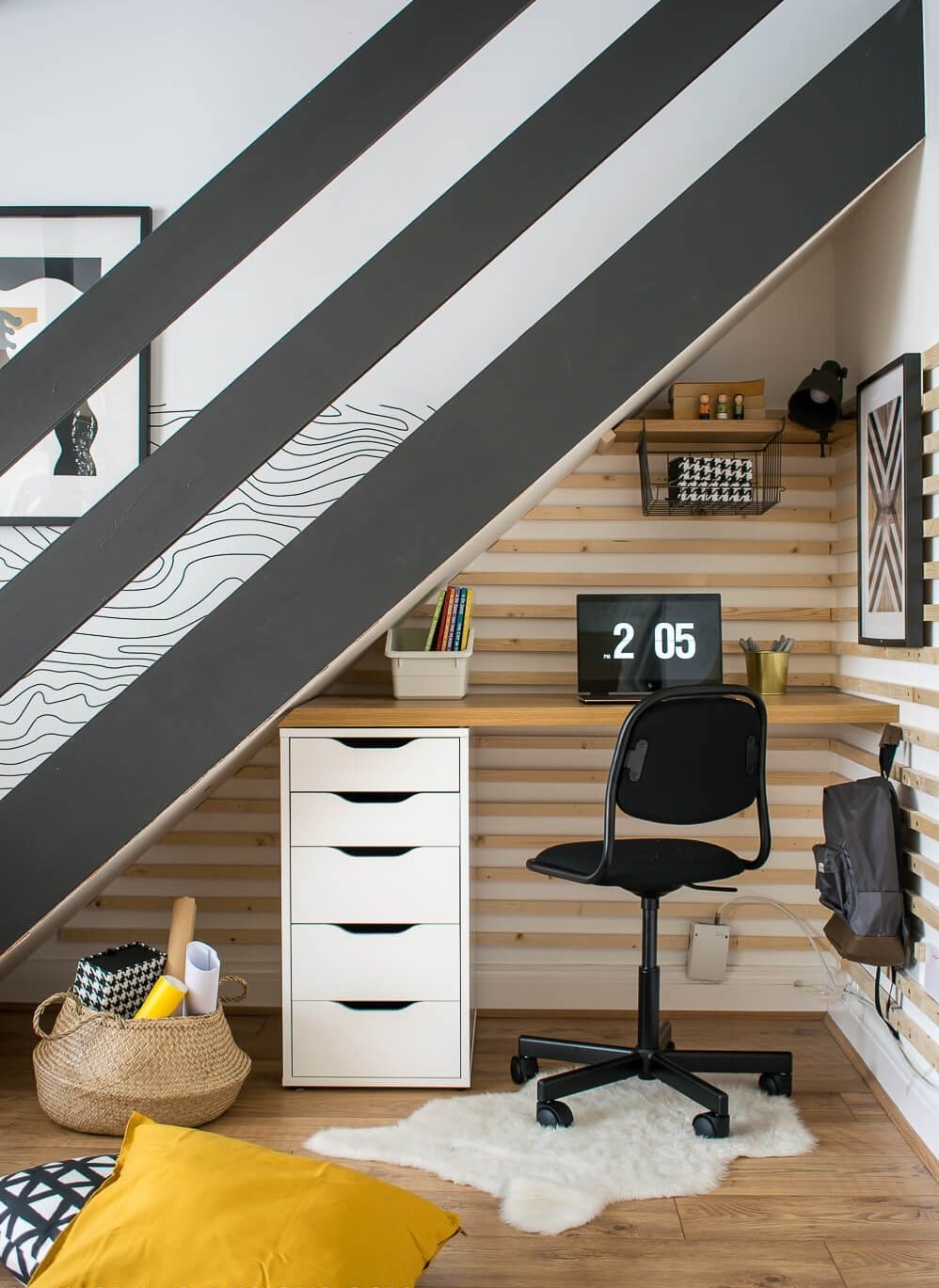 a desk under a staircase
