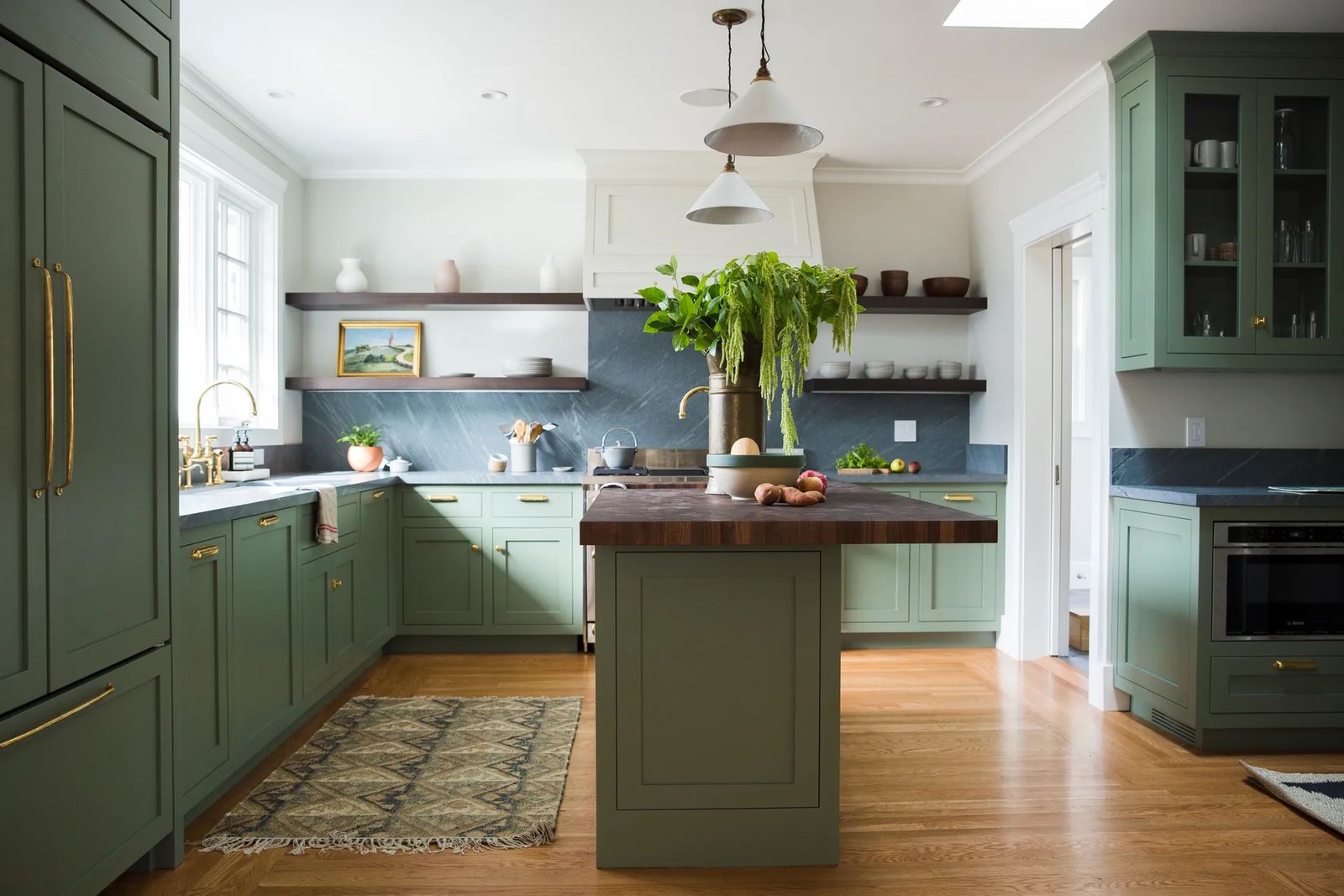 Image may contain Indoors Kitchen Interior Design Kitchen Island Plant Home Decor Rug Art and Painting
