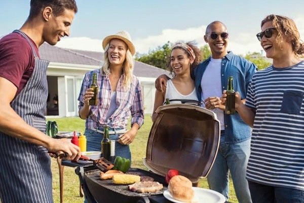 A man cooks at a grill.
