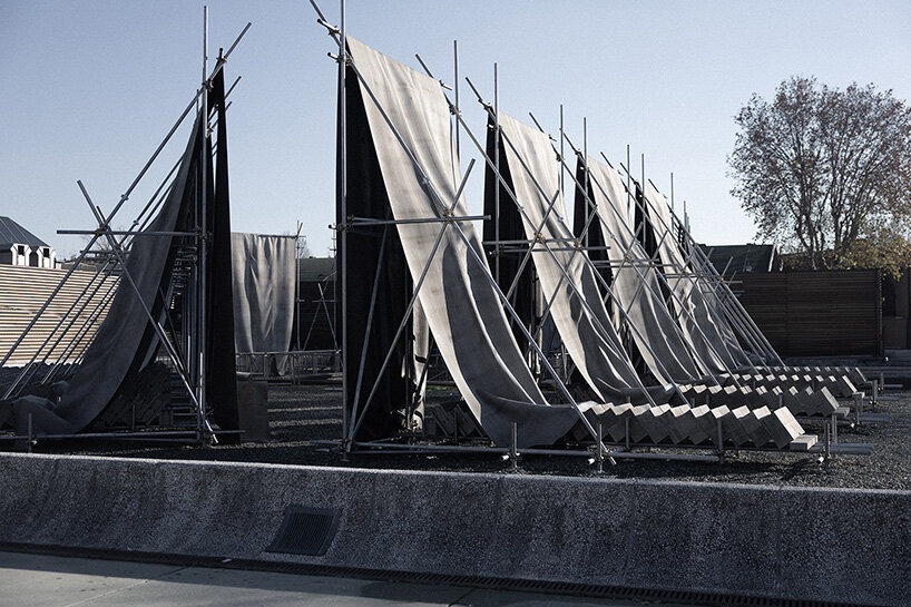 concrete canvas wraps 18 scaffolding monoliths for monumental installation in florence