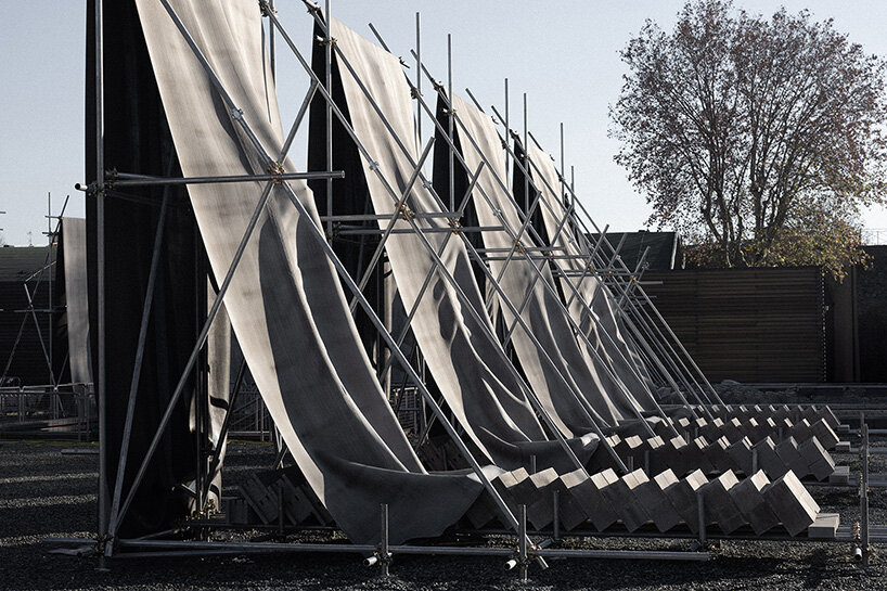 concrete canvas wraps 18 scaffolding monoliths for monumental installation in florence