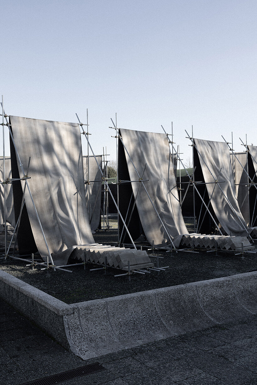 concrete canvas wraps 18 scaffolding monoliths for monumental installation in florence