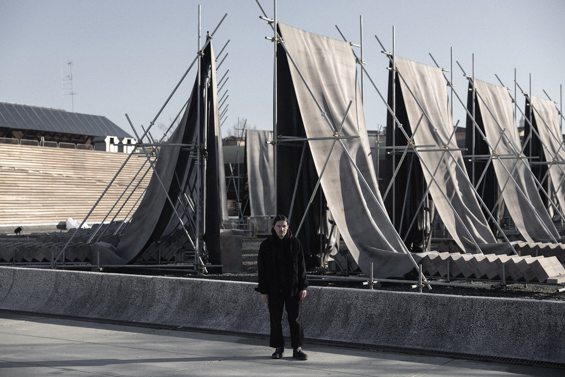 concrete canvas wraps 18 scaffolding monoliths for monumental installation in florence